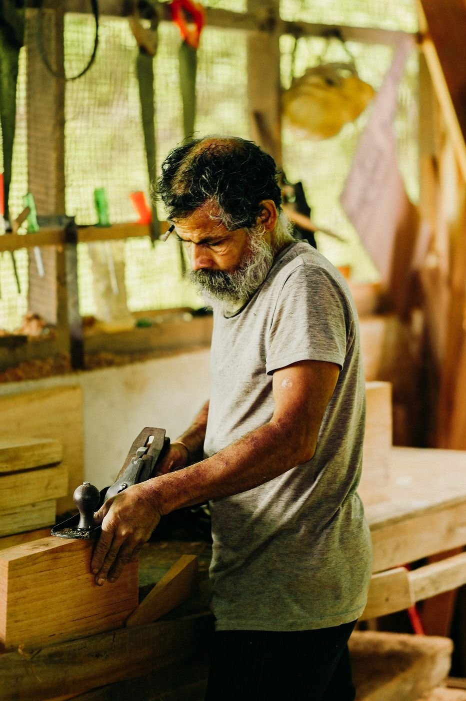 The master carpenter planing a beam