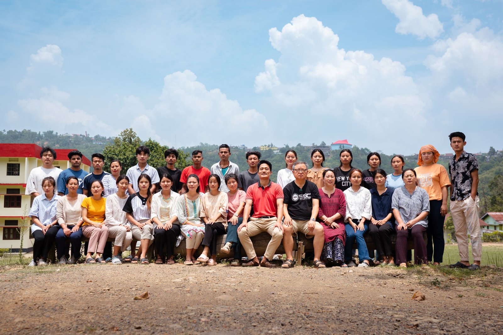 The cooperative's employees seated together outside the Zunpha office