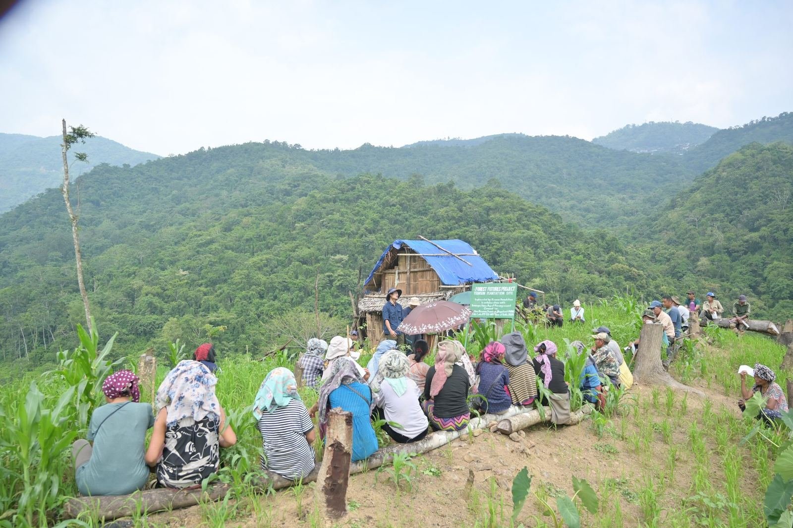 A community meeting on a hillside