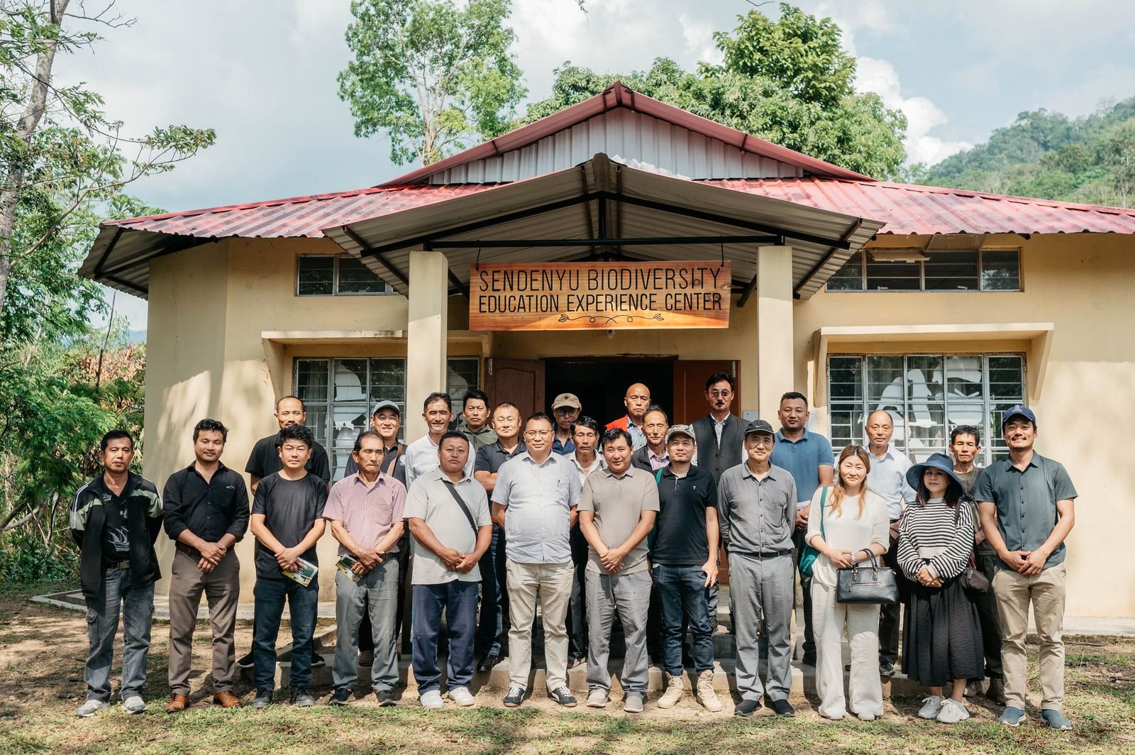 Kenono staff, local villagers, and visitors in front of the Sendenyu Biodiversity Education Experience Centre