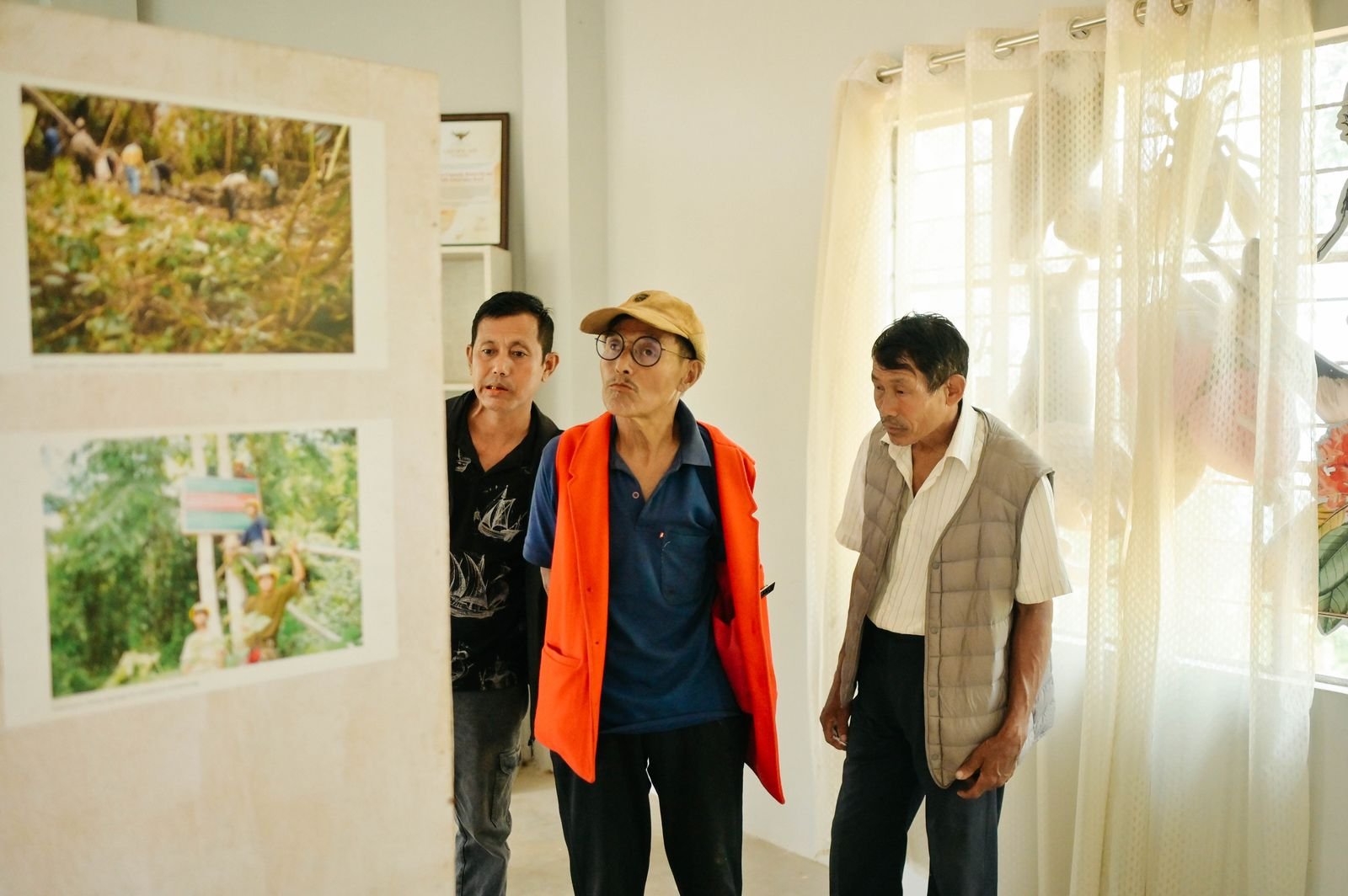 Village elders looking at the exhibition panels inside the centre